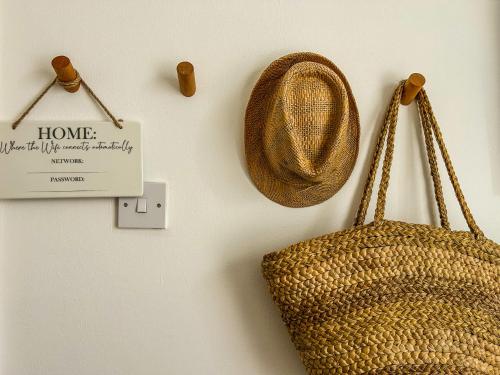 a straw bag and a sign on a wall at J&W Apartments with free parking in Liverpool