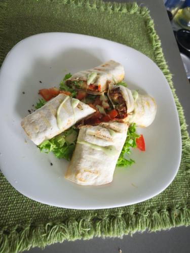 a white plate with some food on a salad at Casa Marlui-San José in Curridabat