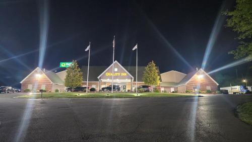 a building with flags in front of it at night at Quality Inn Dublin I-81 in Dublin