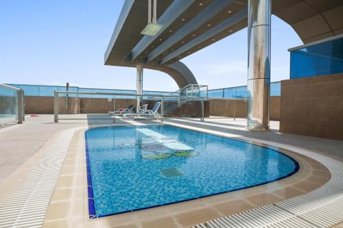 a swimming pool on the roof of a building at Stylish studio at Sports City in Dubai