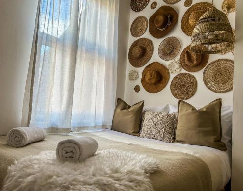 a bedroom with a bed with hats on the wall at J&W Apartments with free parking in Liverpool