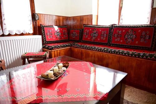 a living room with a red couch and a table at Rustic House in Miléa