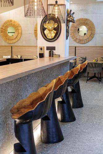 a bar with benches in front of a counter at Hotel Ecos del Sella in Cangas de Onís