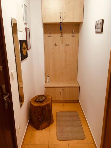 a bathroom with a tree stump in the middle of a room at Apartmán Corvin in Veľký Meder