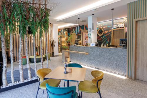 a restaurant with chairs and a table and a counter at Hotel Ecos del Sella in Cangas de Onís