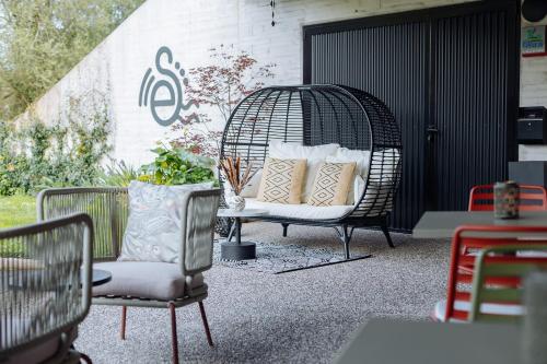 a bird cage with pillows on a patio at Hotel Ecos del Sella in Cangas de Onís