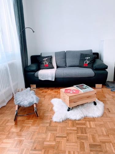 a living room with a couch and a coffee table at Holiday Escape Studio - Stylish & Central - steps to Matterhorn gondola in Zermatt