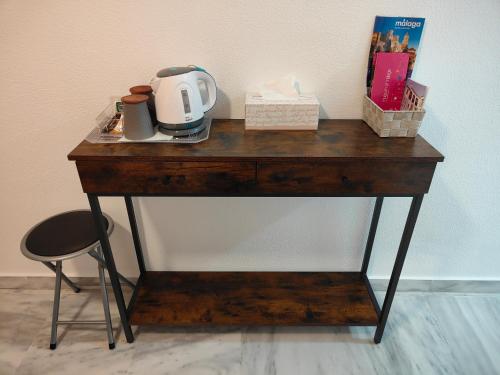 uma mesa de madeira com um aparelho em cima em Suite Salitre12 em Málaga