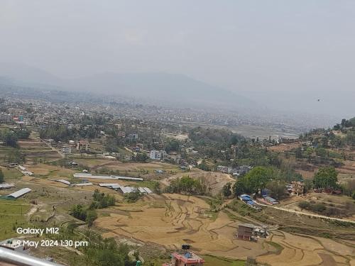 an aerial view of a city with fields and buildings at Godamchaur Villa in Lalitpur