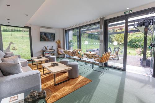 a living room with a couch and a table and chairs at Hotel Ecos del Sella in Cangas de Onís