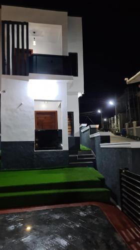 a building with some green grass and a building at A and T apartment in Ikorodu