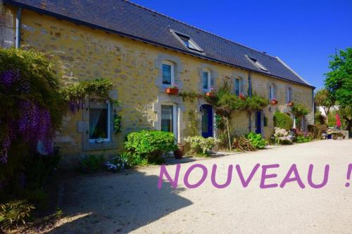 a house with flowers in the front of it at Le Chêne in Névez