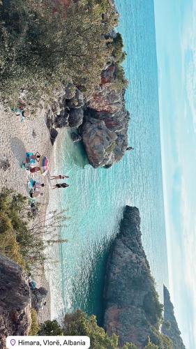 a group of people on a beach near the water at Camping Aquarium in Himare