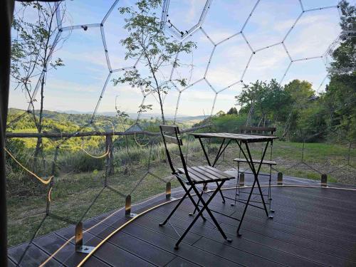 a table and chair on a wooden deck with a view at Camping Paradiso in Pesaro