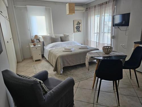 a bedroom with a bed and a table and chairs at Rooftops in Kavala