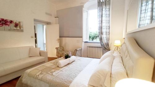a bedroom with a large bed and a couch at CINQUE TERRE MONEGLIA in Moneglia