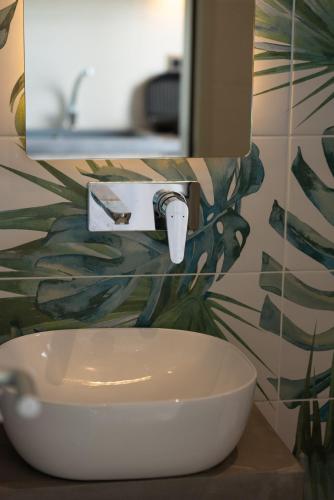 a bathroom with a white sink and a mirror at Horeizons Modern Living in Nea Vrasna
