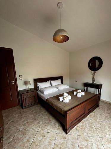 a bedroom with a large bed with white pillows at Ariadnishouse in Néa Karváli