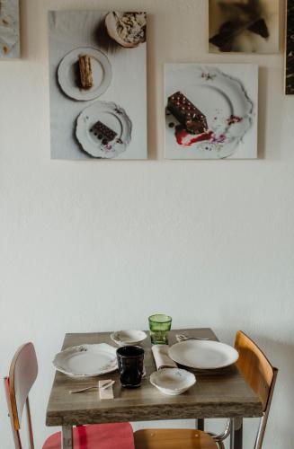 a wooden table with plates on top of it at Ca' Nadin Agriturismo in San Damiano dʼAsti