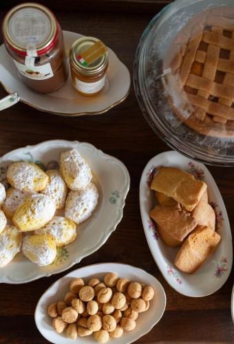 a table with plates of bread and waffles and eggs at Ca' Nadin Agriturismo in San Damiano dʼAsti