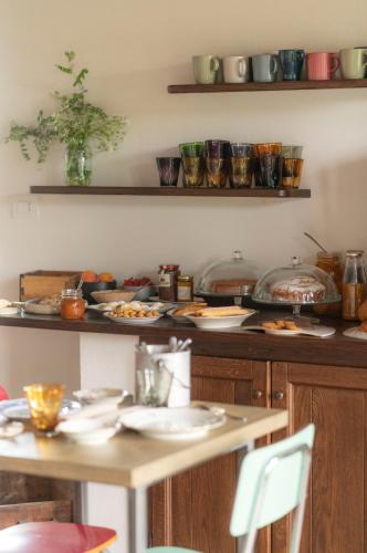 a table with plates of food on a counter at Ca' Nadin Agriturismo in San Damiano dʼAsti