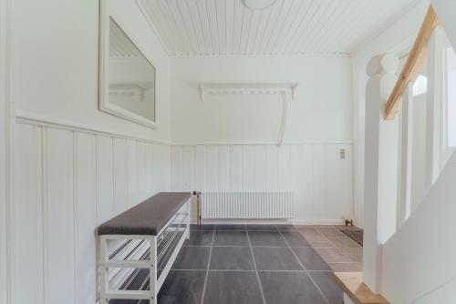 a room with a bench in the middle of a room at Charming 2BR Retreat in Vestmanna in Vestmanna