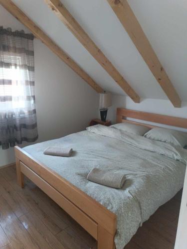 a bed with two pillows on it in a bedroom at Naš san in Vrdnik