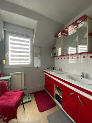 bagno con armadi rossi e tappeto rosso di Kathy Room a Bénouville