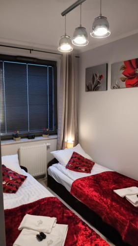 a bedroom with two beds and a window at Planet Gdansk Apartments Mercure Old Nova in Gdańsk