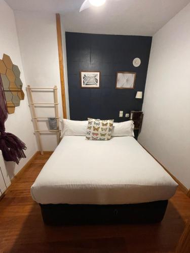 a bedroom with a large bed with a black headboard at El Torreon de Navacerrada in Navacerrada