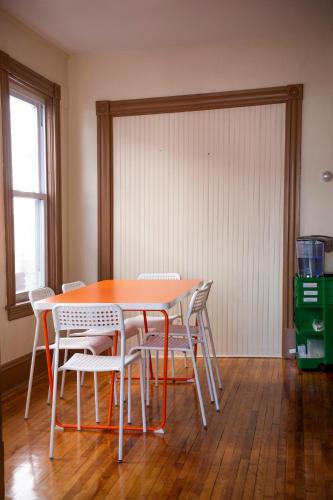 a dining room table with white chairs around it at My Cousins Place in Burlington