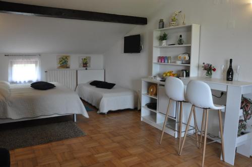 ブゼトにあるGuest House Mostのベッドルーム1室(ベッド1台、デスク、白い椅子2脚付)