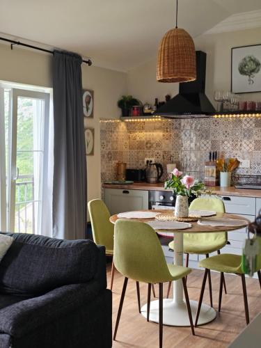 a kitchen with a table and chairs in a room at Apartment Mint&Rose in Risan