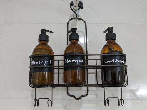 a rack with four bottles of alcohol in it at Begaso Family Winery in Kvareli