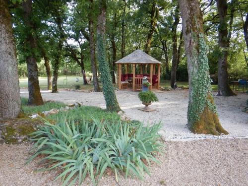 a gazebo in the middle of a park with trees at Domaine de Nineyrolle in Azerat