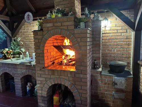 a brick oven with a fire in it at Casa Antonia in Chişcău