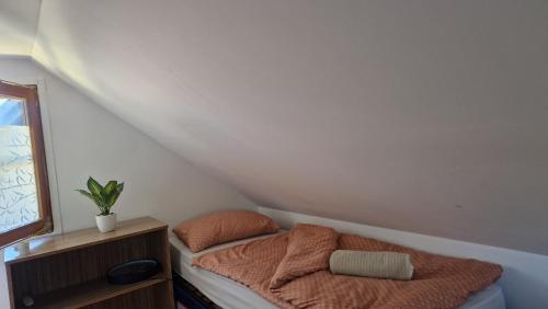 a small bed in a corner of a room at Apartma Zala-Terme Čatež in Mostec
