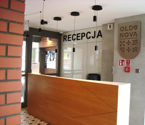 a lobby with a reception desk in a building at Planet Gdansk Apartments Mercure Old Nova in Gdańsk
