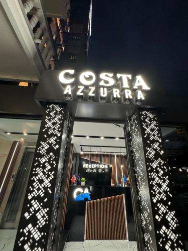 a store with a sign that reads costa a supreme at Apartments Costa Azzurra in Velipojë
