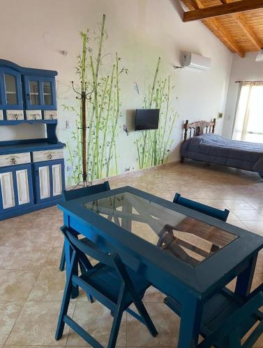 a blue table and chairs in a living room at La Casita Yogui - MONOAMBIENTE 2 in Santa Rosa de Calamuchita