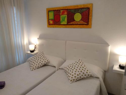a white couch with two pillows in a room at CASA DANIELA APARTAMENTOS-The pilgrim's house apartments in Estella