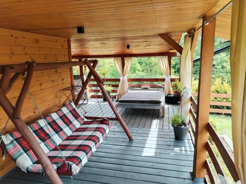 a porch with two hammocks in a cabin at Roztocze, Domek Na Leśnym Wzgórzu,Krasnobród,Zamość,Zwierzyniec in Zamość