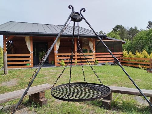 a swing in front of a log cabin at Roztocze, Domek Na Leśnym Wzgórzu,Krasnobród,Zamość,Zwierzyniec in Zamość