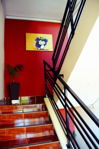 a stairway with a red wall and a red wall at Hotel Puesta del Sol by Nobile in Encarnación