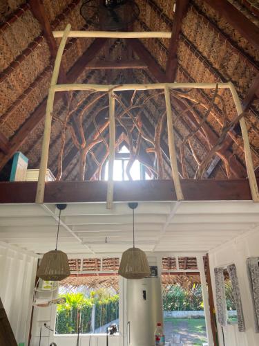 a room with a wooden ceiling with two pendant lights at Fare Tārona in Fare