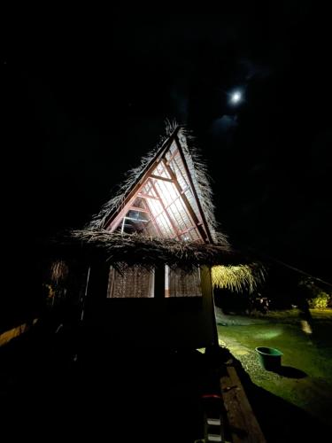 a house at night with the moon in the background at Fare Tārona in Fare