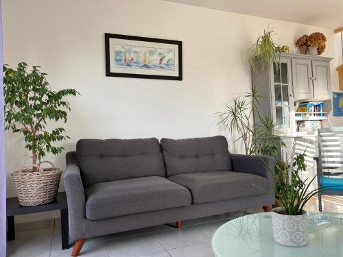 a living room with a couch and a table at Maison Molène, au Pays des Abers Plouguerneau in Plouguerneau