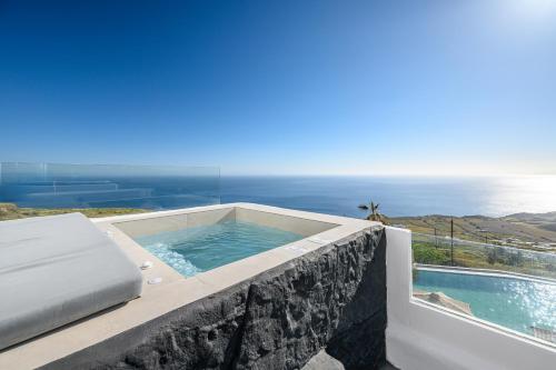 a swimming pool sitting on top of a house at Leon Luxury Suites in Imerovigli