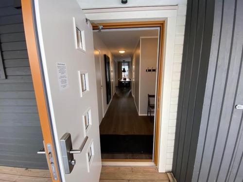 a hallway with a door open to a hallway with a hallway at Kungsberget Åhus H6 - ski apartment with sauna in Järbo