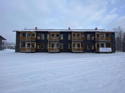 a large building with snow in front of it at Kungsberget Åhus H6 - ski apartment with sauna in Järbo